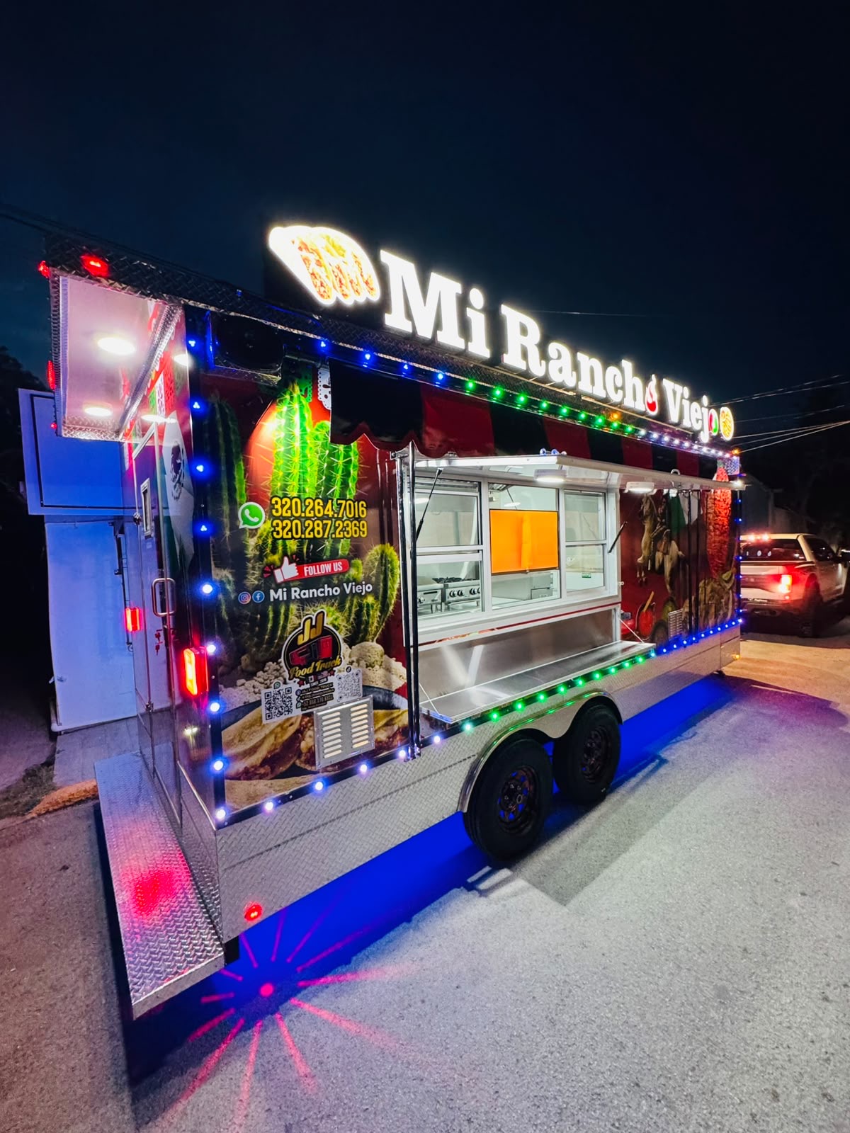 Mi Rancho Viejo food trailer lit up at night with LED lighting